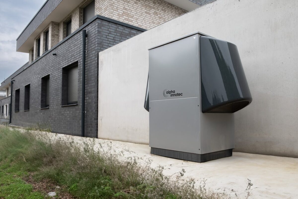 about-01 Innovative heat pump system by alpha innotec installed outside a contemporary building.